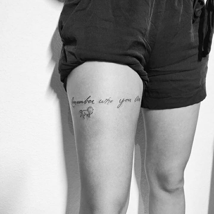 Thigh tattoo saying “Every saint has a past, every
