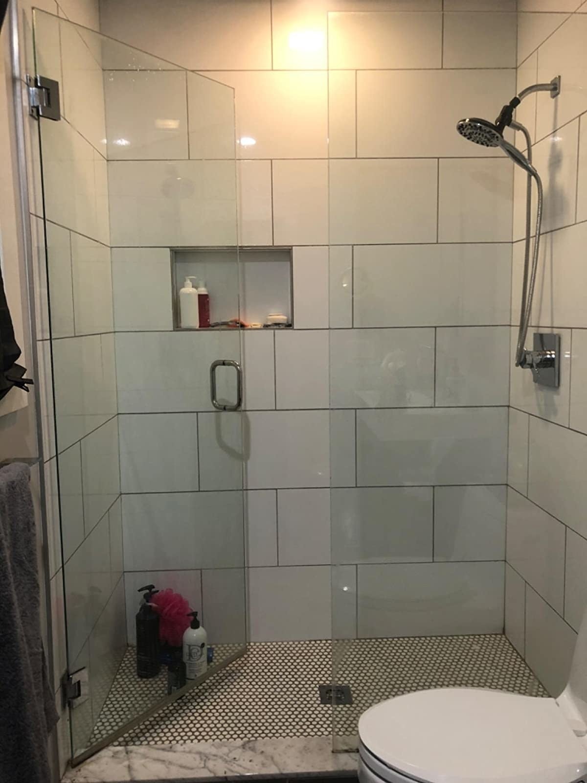 A reviewer’s gleaming clean shower with pristine glass doors
